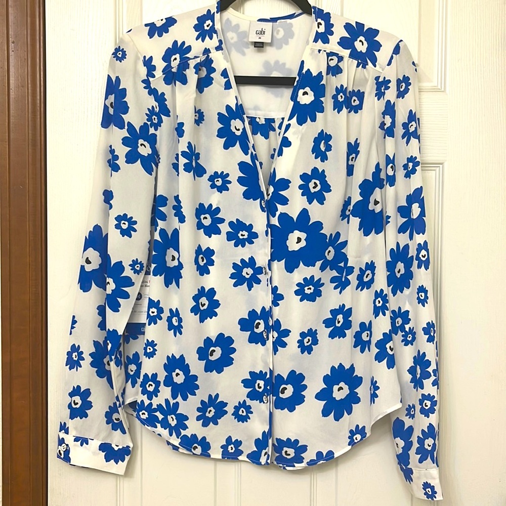 This blue and white Florist Blouse is 100% Polyester.